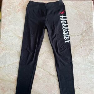 Black Hollister Co. leggings with white and red lettering